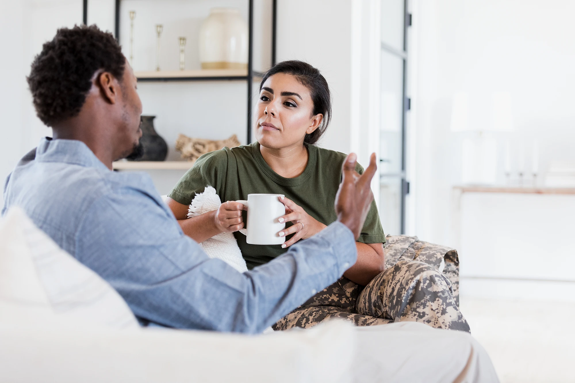 Man and woman having a conversation on the couch