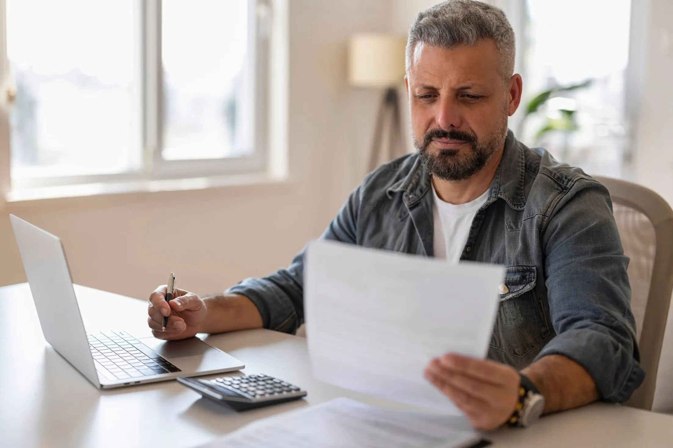 man looking at finances at the table