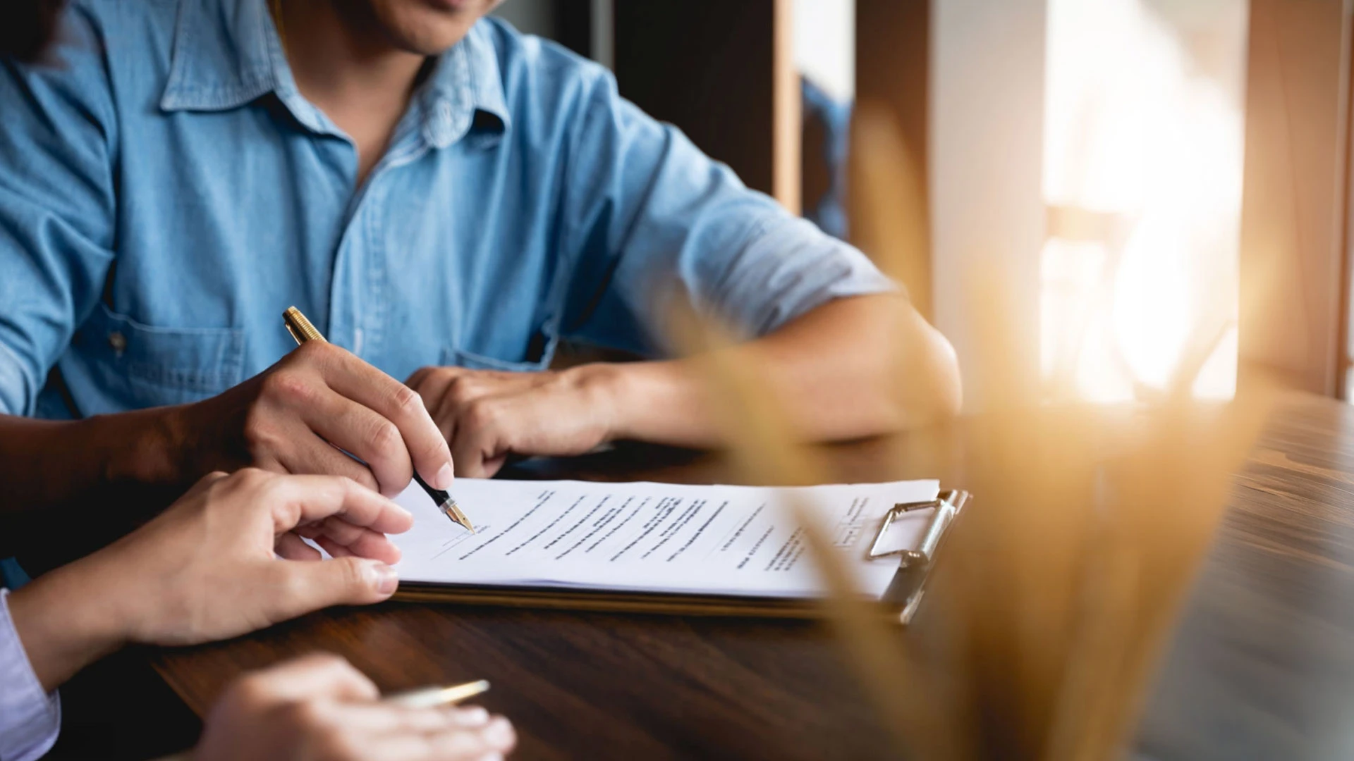 image of a client signing paperwork