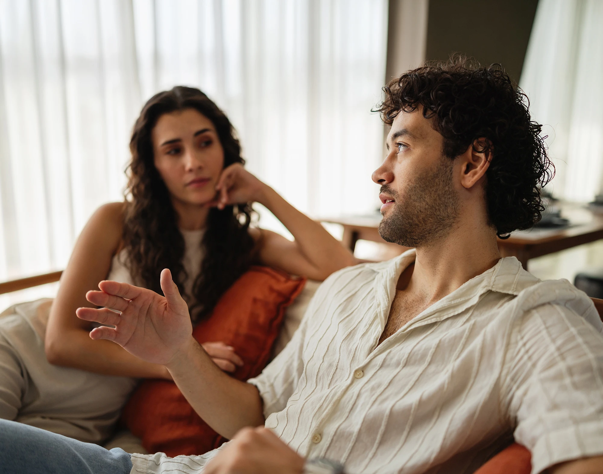 Couple having a serious conversation on the couch